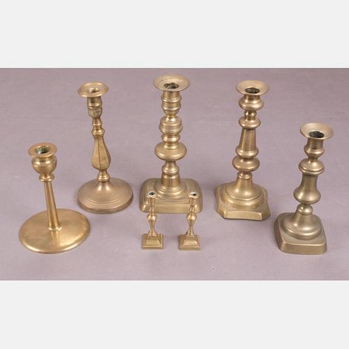 A Group of Seven English Brass Candlesticks, 19th/20th Century.