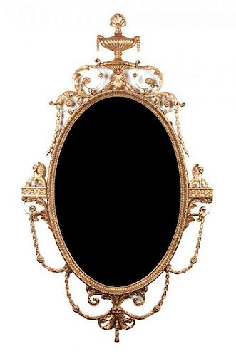 * A Pair of Italian Gilt Gesso Oval Mantel Mirrors 63 x 36 inches.