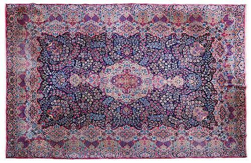 A Kirman Carpet 13 feet 11 inches x 9 feet 9 1/2 inches.