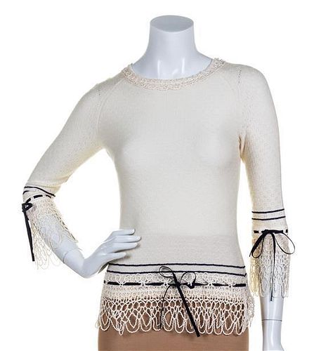 * A Carolina Herrera Cream Sweater, Size S.