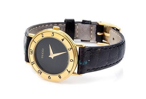 * A Gucci Goldtone Wristwatch, 7" x 1".