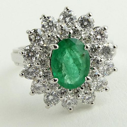 Lady's 1.60 Carat Oval Cut Emerald, 1.45 Carat Round Cut Diamond and 14 Karat White Gold Ring.
