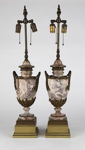 A pair of gilt bronze-mounted carved stone lamps
