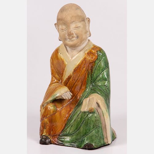 A Chinese Sancai Glazed Stoneware Figure of a Seated Monk