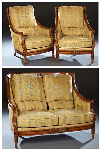 French Three Piece Louis XVI Style Ormolu Mounted Carved Cherry Parlor Suite, 20th c., consisting of a settee and two bergeres, the curved upholstered