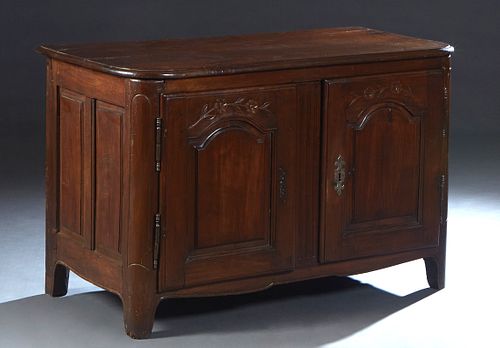 French Provincial Louis Philippe Carved Oak Sideboard, 19th c., the rounded corner top over double fielded panel cupboard doors with iron fiche hinges