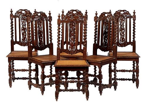 Set of Six French Henri II Style Carved Oak Dining Chairs, c. 1880, the canted back with a leaf carved crest flanked by finials, above a leaf carved s