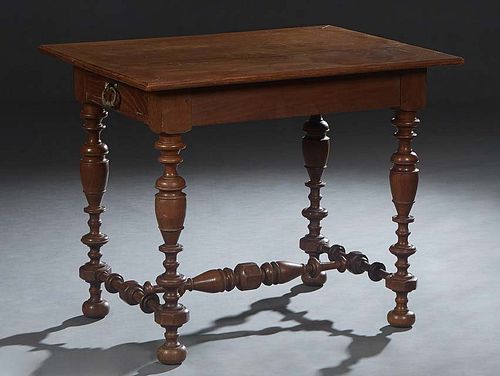 French Louis XIII Style Carved Oak Writing Table, 19th c., the ogee edge rectangular top over a wide skirt with one edge frieze drawer, on turned tape