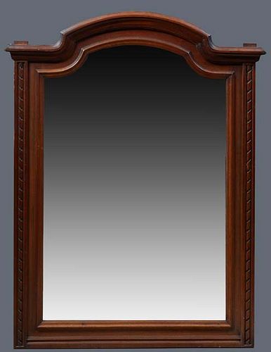 French Louis XVI Style Carved Walnut Overmantel Mirror, late 19th c., the stepped arched crown over a twist carved frame around an arched wide beveled