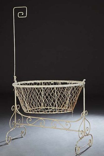 French Wrought Iron Rocking Cradle, 19th c., with a mosquito netting hook on one end, with canted knotted cord sides, H.- 70 1/2 in., W.- 42 1/2 in., 