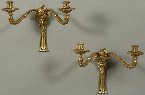 Pair of Bronze Two Light Wall Sconces, 20th c., the grotesque Bacchus head mounted back plate issuing two curved candle arms with wide bobeches, not e
