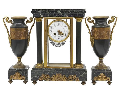 20th Century three piece French marble garniture 20th Century Three piece French marble garniture

The clock flanked by two footed vases with addors