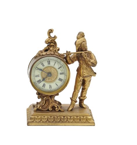 American Ansonia New York figural clock American Ansonia New York figural gilt metal clock, Roman numeral face with a figure of a man playing the flut