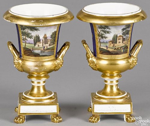 Pair of Paris porcelain urns, 19th c., decorated with hand painted landscapes with figures