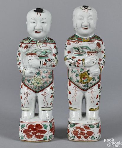 Pair of Chinese famille verte figures of Ho Ho boys, early 19th c., each holding a vase