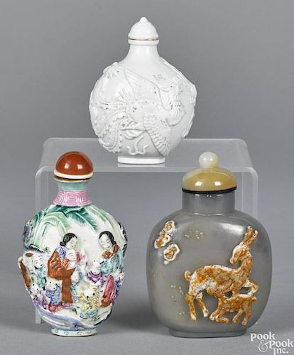 Three Chinese snuff bottles, to include a molded porcelain bottle with bird and dragon decoration