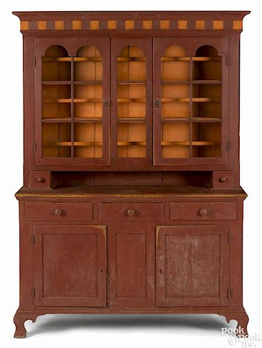 Pennsylvania painted poplar two-part Dutch cupboard, ca. 1800, retaining a later red surface