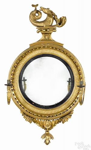 Giltwood convex mirror, ca. 1800, with a sea serpent crest and two girandole arms, 48 1/2'' h.