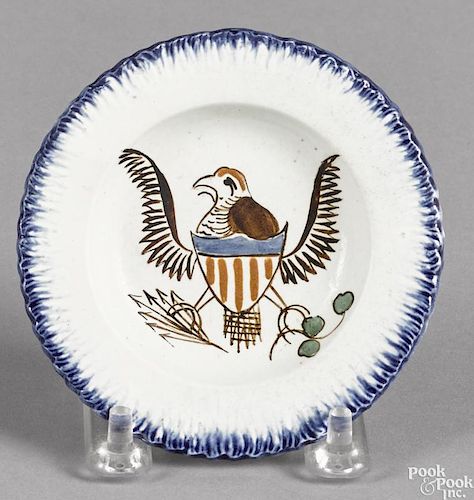 Pearlware blue feather edge cup plate, 19th c., with an American eagle decoration, 3 7/8'' dia.