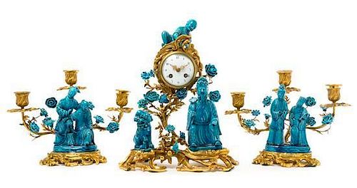 A French Gilt Bronze and Chinese Porcelain Clock Garniture Height of clock 15 inches.