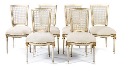 A Set of Six Louis XVI Style Painted and Parcel Gilt Dining Chairs Height 35 1/2 inches.