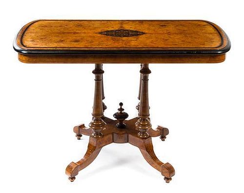 A Victorian Parcel Ebonized Burlwood Center Table Height 29 1/2 x width 42 x depth 23 inches.