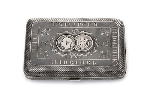 * A Russian Niello Silver Cigarette Case, Late 19th century, the lid centered with two Bulgarian silver lev coins beneath a coro