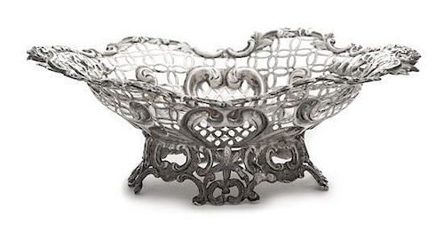 A Victorian Silver Basket, Likely William Comyns, London, 1890, having a pierced body with a C-scroll and floral decorated rim a