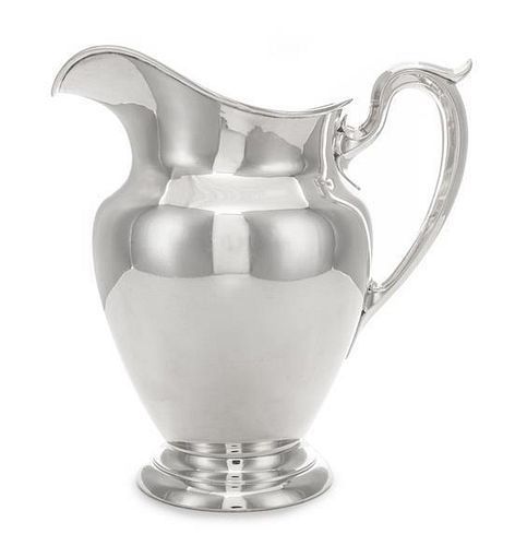 * An American Silver Water Pitcher, Gorham Mfg. Co., Providence, RI, 1943, of plain vase form with an upswung loop handle.