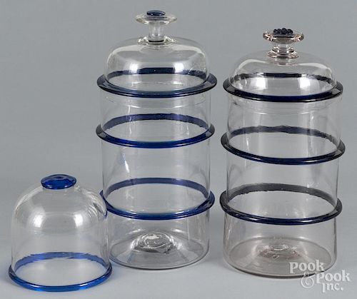 Pair of colorless glass canisters, 20th c., with cobalt bands, 11'' h. and 11 1/2'' h.