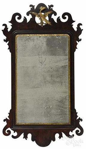 Chippendale mahogany looking glass, late 18th c., with a parcel gilt phoenix crest, 32'' h.