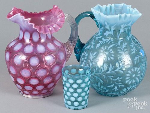 Two opalescent glass pitchers, 8 1/2'' h. and 9'' h., together with a cup, 3 3/4'' h.