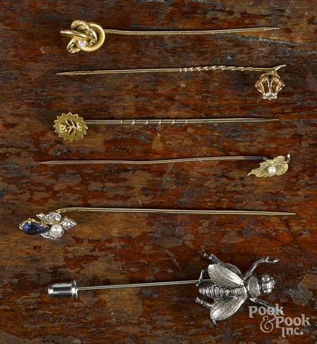 Six stick pins, to include a Gorham sterling silver fly pin, a yellow gold knot pin with an opal