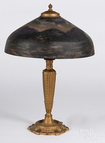 Gilt metal table lamp, early 20th c., with a reverse painted shade, 23'' h.