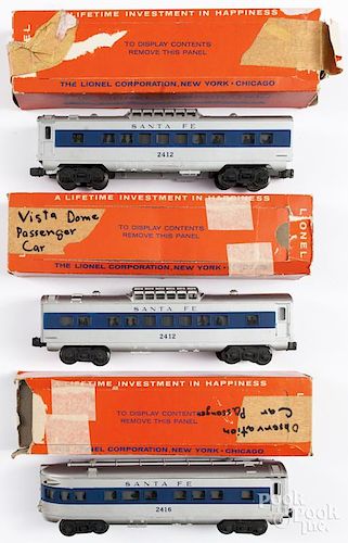 Three Lionel train cars, to include a 2416 and two 2412 passenger cars, in their original boxes.