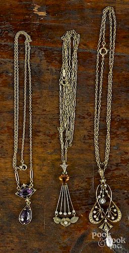 Three lavaliers, all with 14K yellow gold chains, to include examples with seed pearls, amethyst