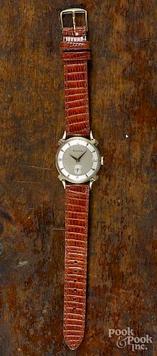 Bulova wristwatch with a 14K gold case and a teju lizard band, size 16.