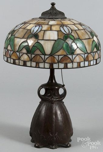 Art Nouveau patinated white metal table lamp, early 20th c., with a leaded glass shade, 23'' h.
