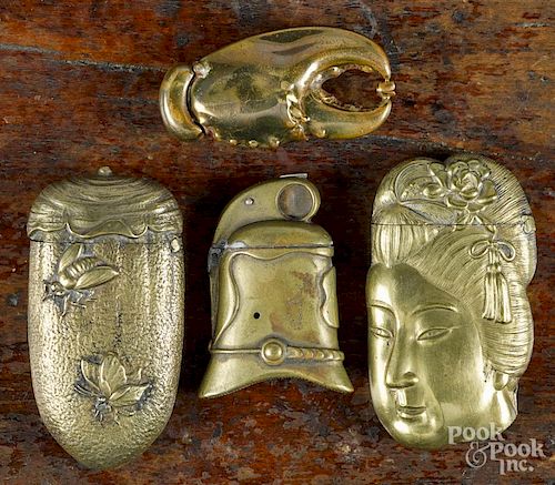 Four brass match vesta safes, ca. 1900, to include a Geisha, a lobster claw, a helmet, and a flower bud