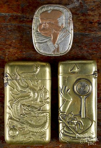 Two Japanese embossed brass match vesta safes, ca. 1900, one with a compass, 2 1/2'' l.