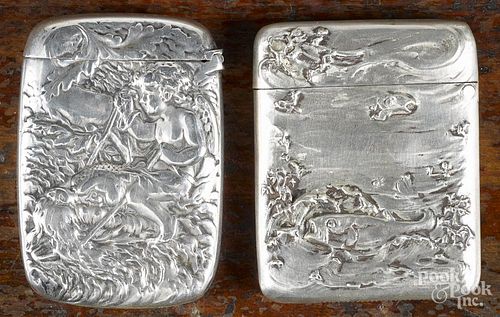 Two sterling silver embossed fish match vesta safes, ca. 1900, one with an embossed scene