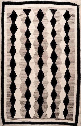 A 1940s NAVAJO RUG WITH ALL-OVER FIELD DESIGN