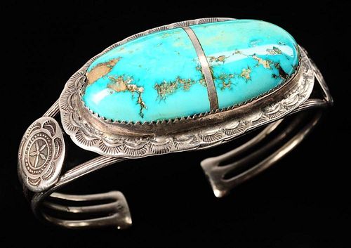 A LARGE SILVER AND TURQUOISE CUFF BRACELET