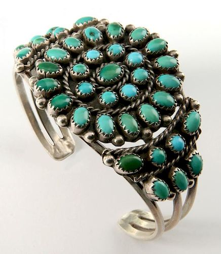 A ZUNI STERLING SILVER AND TURQUOISE BRACELET
