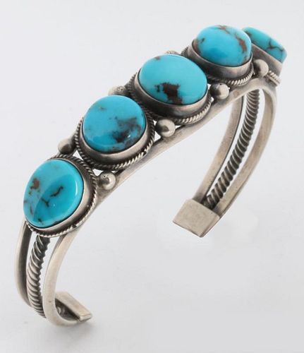 A STERLING SILVER CUFF BRACELET WITH TURQUOISE