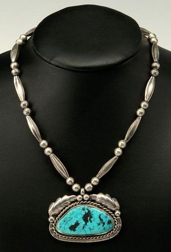 A STERLING SILVER AND TURQUOISE PENDANT