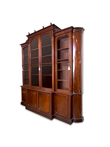 An English Mahogany Breakfront Bookcase Height 122 x width 129 x depth 25 1/2 inches.