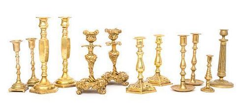 A Collection of Twelve Brass Candlesticks