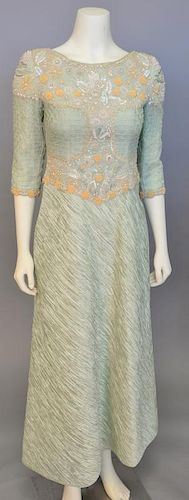Mary McFadden, c. 2000, Evening gown with skirt of bias-cut crinkled pale green silk and bodice that is hand-embroidered with coils of silver and gold