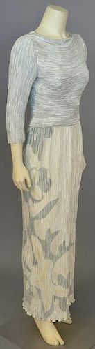 Mary McFadden, c. 1990s, Evening dress of pale seafoam green crinkle-pleated silk; the skirt is printed with a pale, large-scale floral design along r